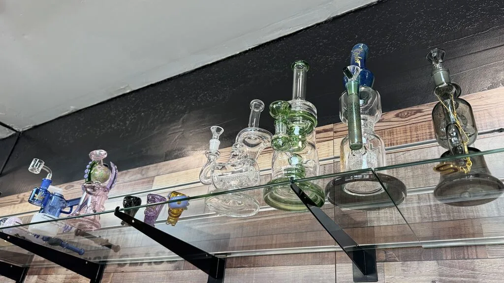 Glass water pipes and rigs on a glass shelf