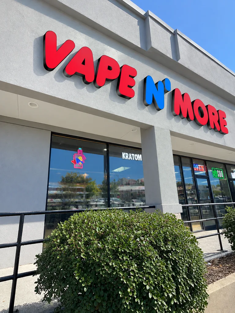 Vape N More storefront with red and blue sign on 61st Street