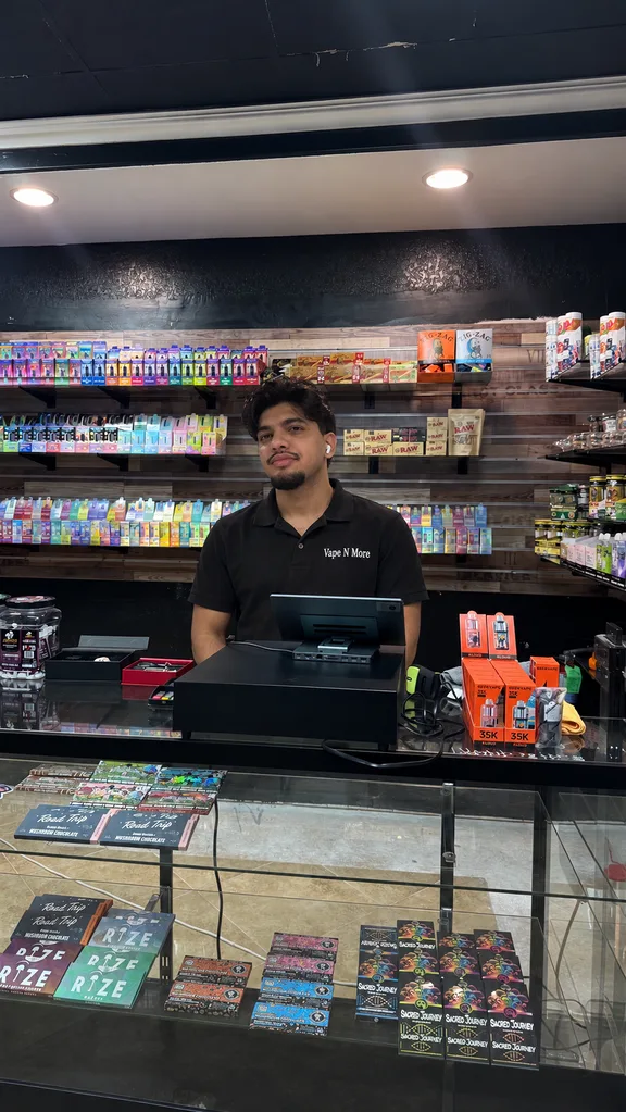 Vape N More team member at the register